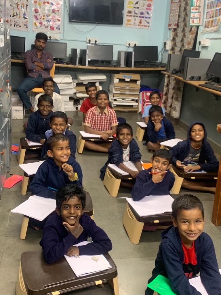 A young boy proudly holding his drawing